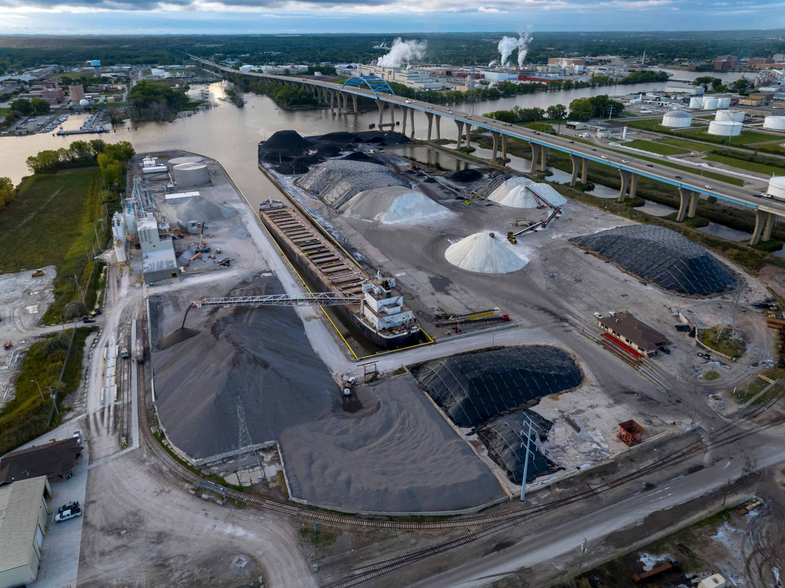 Aerial Shot of GLC Minerals plant with ship in cargo port unloading.